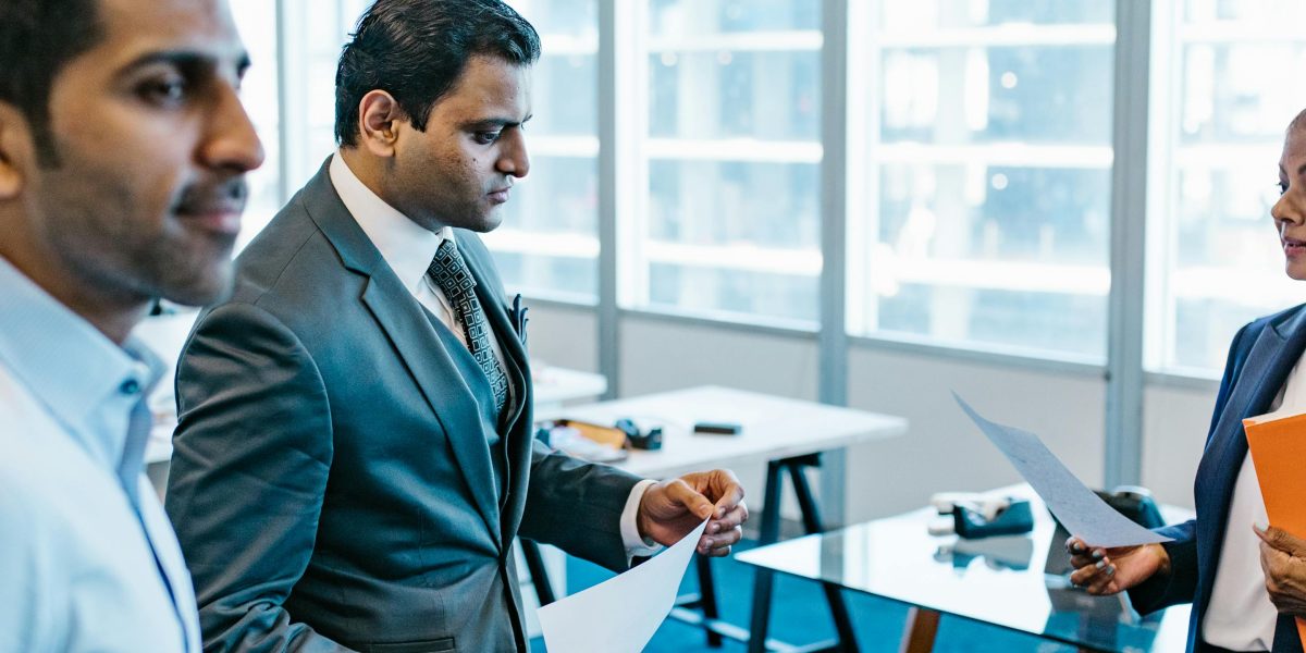 A property buyer consults with a professional to carefully review legal documents and perform due diligence before a purchase.