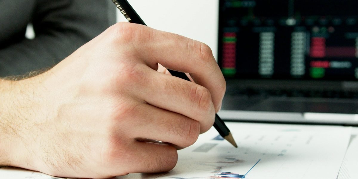 An investor analyzes financial data and reports to understand property prices, ROI, and rental yields in Dubai.