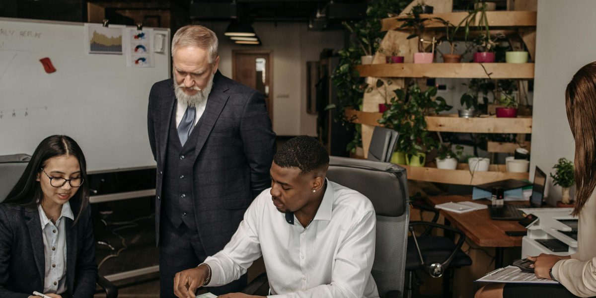 A diverse team actively collaborating in a modern office, reviewing documents or brainstorming strategies.