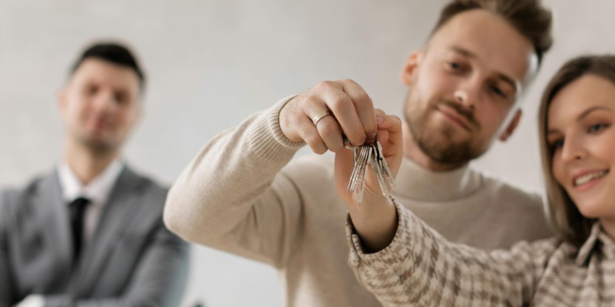 A joyful couple celebrating a new home purchase, holding keys with a sense of achievement and trust.