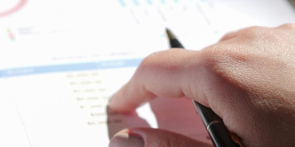 A person carefully examining mortgage agreements or financial statements for a property investment.