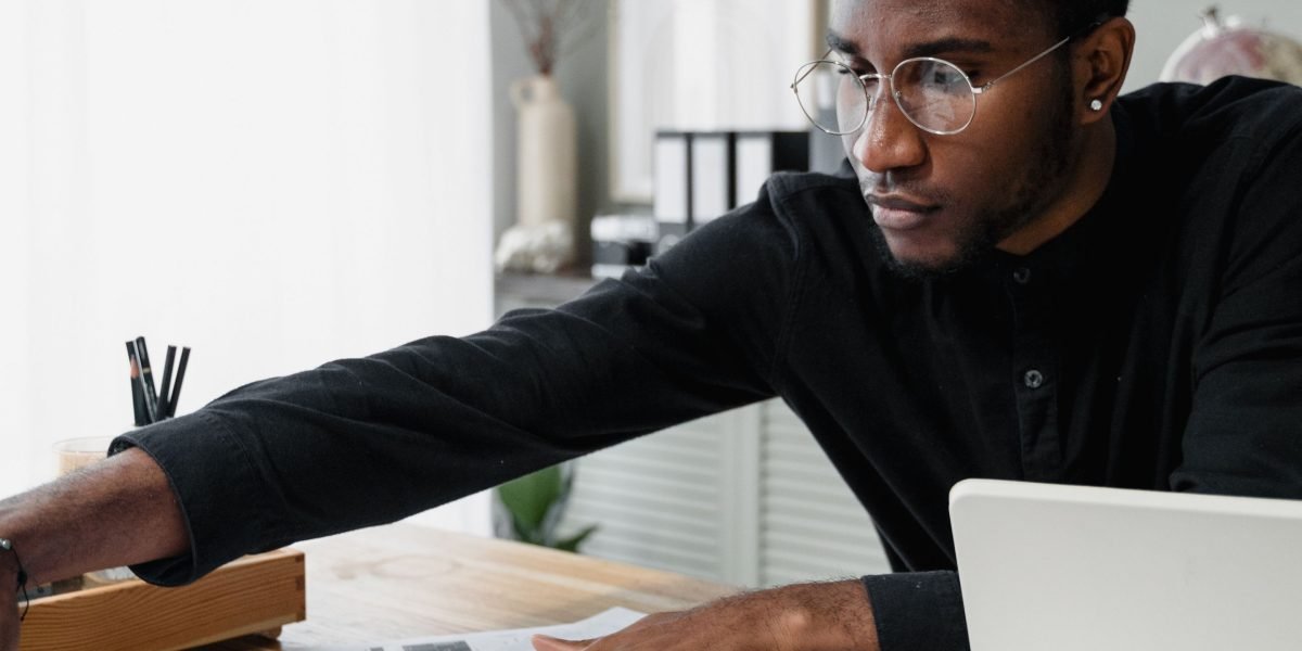 A person intently researching property options for investment in Dubai, emphasizing the importance of thorough due diligence.