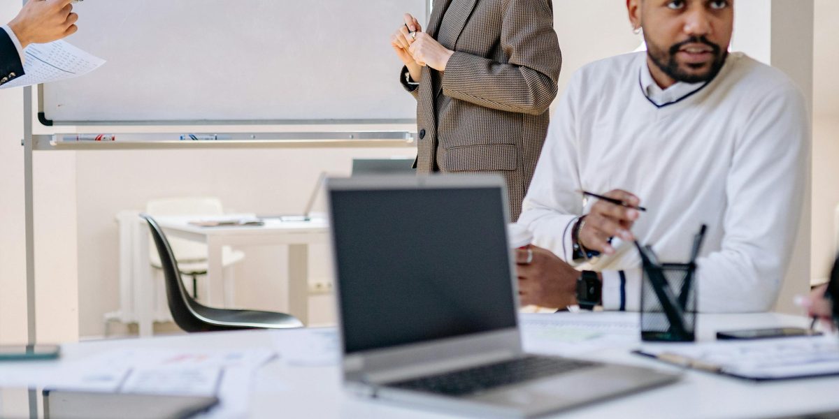 Two professionals discuss strategic plans, emphasizing the critical decision of choosing a marketing agency.