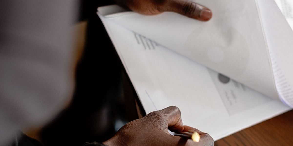 A person carefully reviews a report, symbolizing the evaluation of agency case studies and performance metrics.