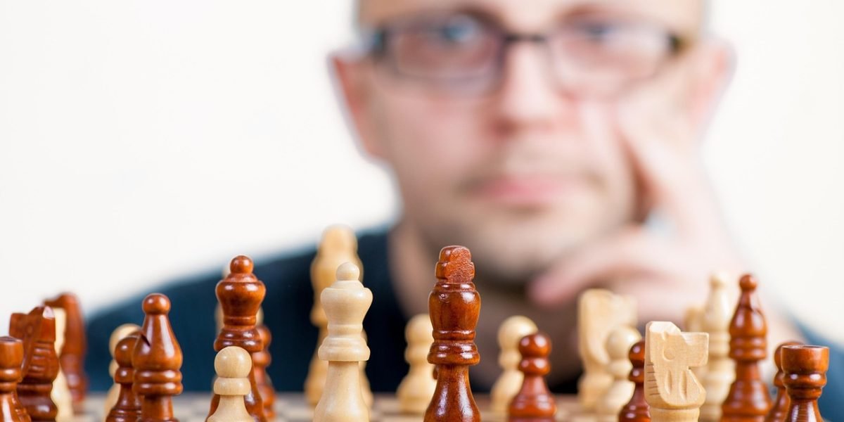 A person intently thinking and strategizing in front of a whiteboard, symbolizing the effort to overcome career challenges.