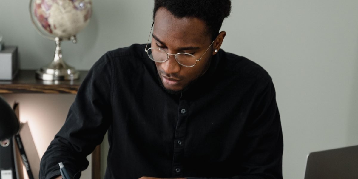 A professional meticulously reviewing financial documents, illustrating the process of planning a marketing budget.