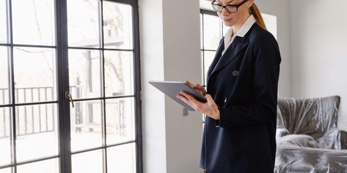 An individual thoughtfully examines property listings, seeking ideal buy-to-let opportunities.