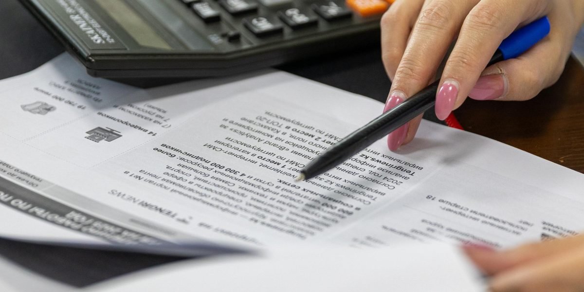 An individual meticulously calculates renovation costs and potential profits for a property flipping strategy.