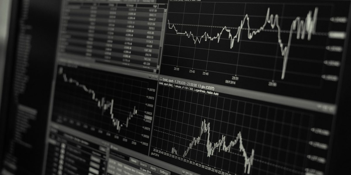 A business team is intently reviewing financial charts and projections, demonstrating data-driven decision-making.