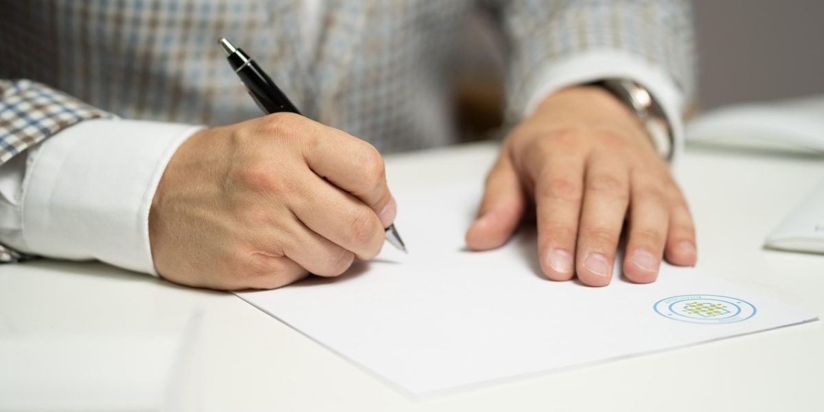 Professionals reviewing and signing important real estate contracts, emphasizing the significance of legal documentation and clear terms.