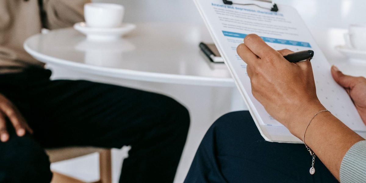 A professional interview in progress, representing the critical questions and vetting process before hiring a real estate consultant.