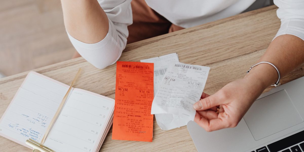 An investor meticulously reviewing financial documents and budgeting for property-related costs.