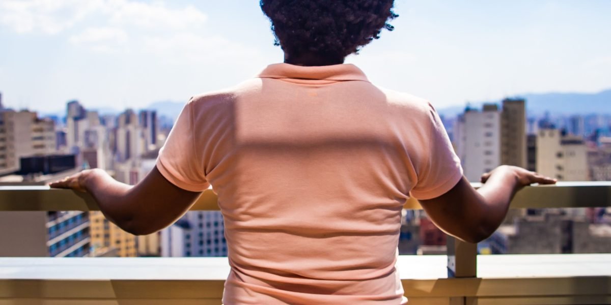 A person confidently looking out at the impressive Dubai cityscape, symbolizing career opportunities and growth.