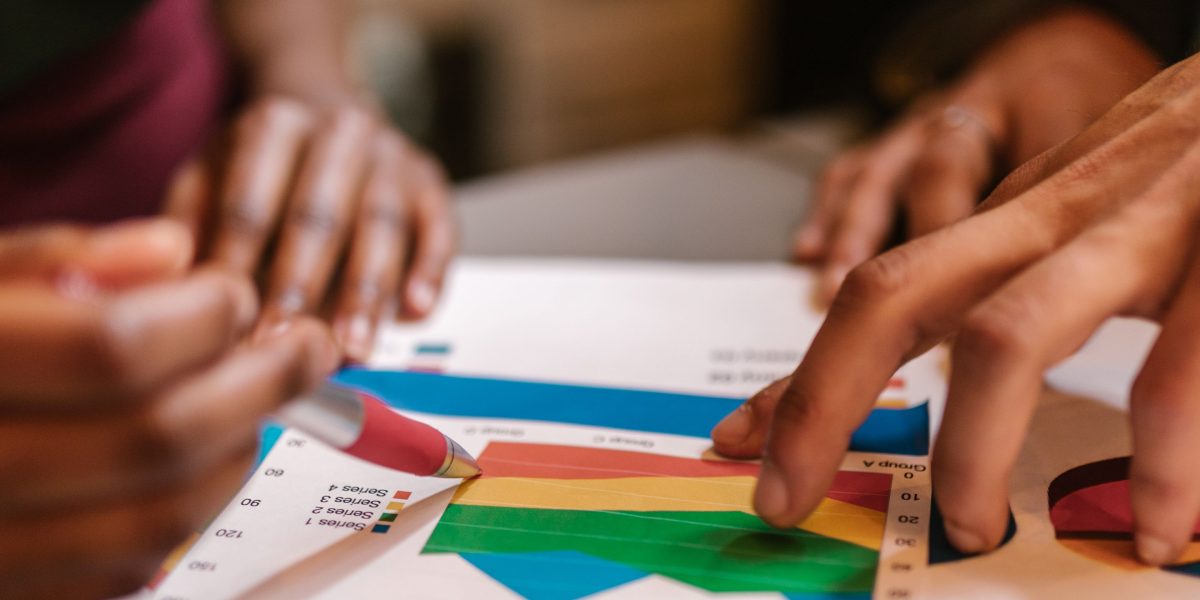 A team of professionals collaborating and analyzing market data on a whiteboard, strategizing to identify high-value customer segments.