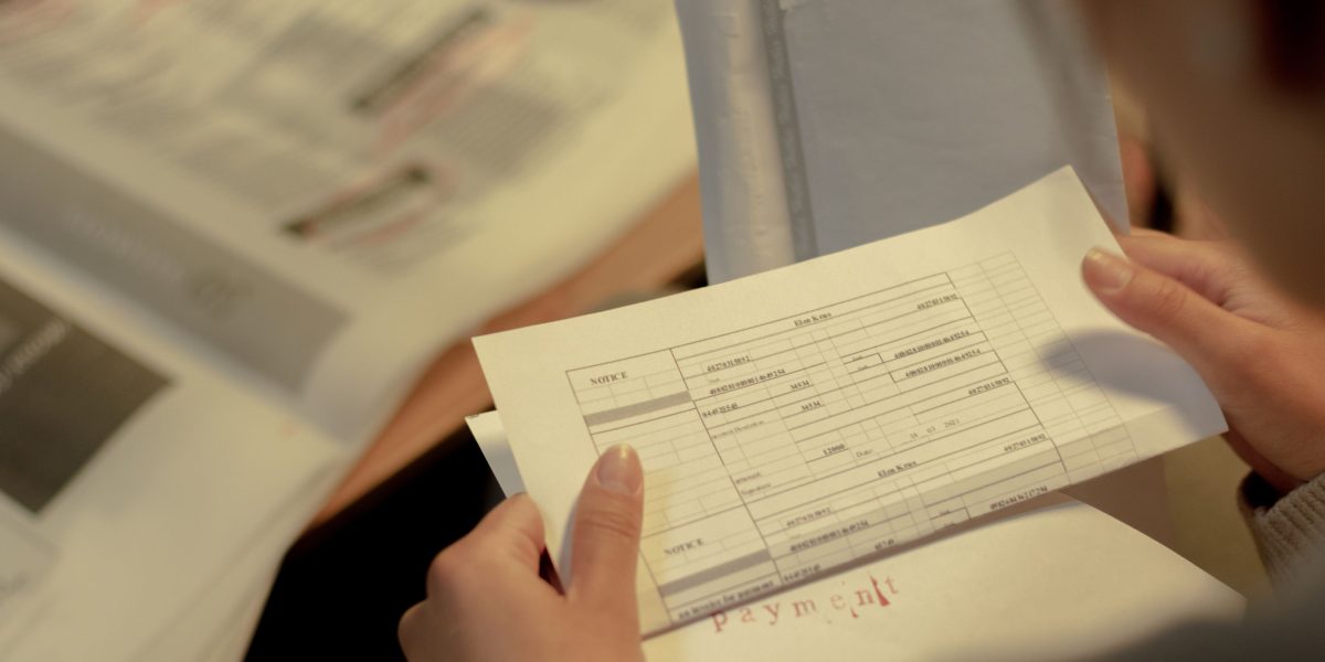 An individual meticulously organizing and reviewing application documents, highlighting preparation for a job search.