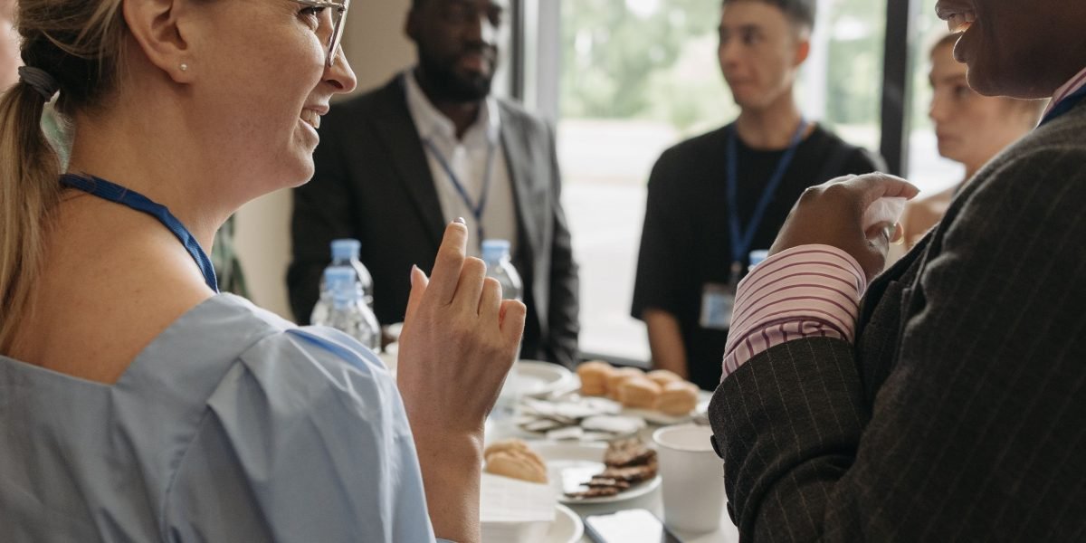 Professionals engaging in conversation at a networking event, representing the importance of connections in career advancement.