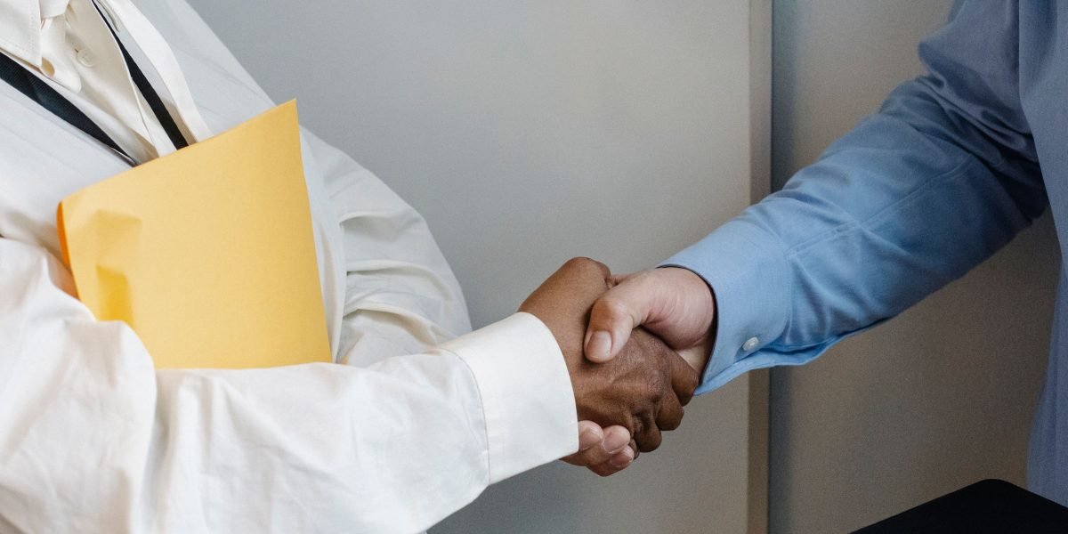 A real estate professional successfully engaging with a client, representing the goal of a conversion-first online presence.